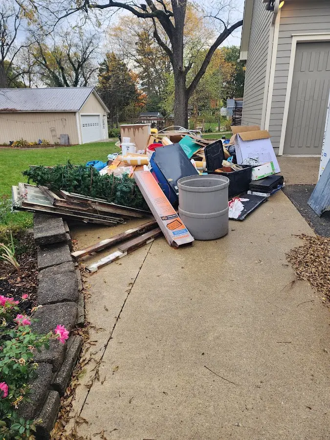 Dumpster being loaded with debris for Estate Cleanout Dumpster Rental in Lake Land'Or